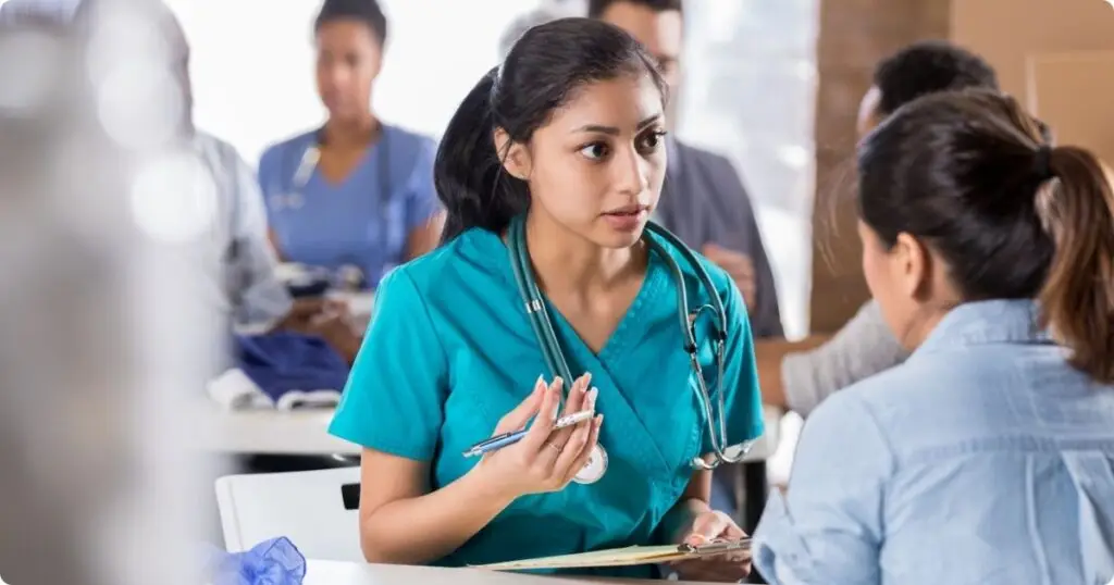 A nurse meeting with hospital leadership, advocating for better workplace support.