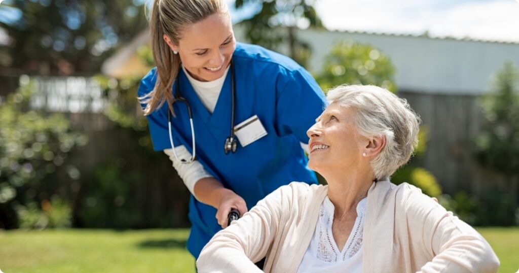 A nurse smiling warmly while interacting wit a patient, symbolizing reconnection with the meaningful aspects of the job.